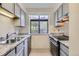 Updated kitchen featuring sleek stainless steel appliances and light cabinets with granite countertops at 12368 W Nevada Pl # 206, Lakewood, CO 80228