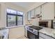 Updated kitchen featuring sleek stainless steel appliances and light cabinets with granite countertops at 12368 W Nevada Pl # 206, Lakewood, CO 80228