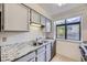 Updated kitchen featuring sleek stainless steel appliances and light cabinets with granite countertops at 12368 W Nevada Pl # 206, Lakewood, CO 80228