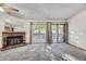 Bright living room features a brick fireplace, sliding glass doors to a balcony, and neutral-colored carpeting at 12368 W Nevada Pl # 206, Lakewood, CO 80228