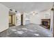 Open-concept living area boasts neutral-colored walls, modern carpeting, brick fireplace, and adjacent kitchen at 12368 W Nevada Pl # 206, Lakewood, CO 80228