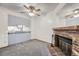 Inviting living area with a cozy brick fireplace adjacent to the kitchen with modern carpeting at 12368 W Nevada Pl # 206, Lakewood, CO 80228