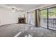 Spacious living room features a brick fireplace, sliding glass doors to a balcony, and neutral-colored carpeting at 12368 W Nevada Pl # 206, Lakewood, CO 80228