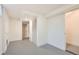 Unfinished basement showcasing concrete floors, white walls, storage and access to other rooms at 9455 W 37Th Ave, Wheat Ridge, CO 80033