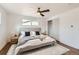 Bright bedroom with hardwood flooring, neutral walls, ceiling fan and a walk-in closet at 9455 W 37Th Ave, Wheat Ridge, CO 80033