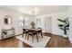 Bright dining room with wood floors, modern light fixture, and bar cart at 9455 W 37Th Ave, Wheat Ridge, CO 80033