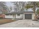 Charming single-story home featuring a gray roof, painted white brick exterior and an attached garage at 9455 W 37Th Ave, Wheat Ridge, CO 80033