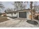View of the single-story painted white brick house featuring an attached gray garage at 9455 W 37Th Ave, Wheat Ridge, CO 80033