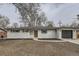 Charming single-story home featuring a white brick exterior, dark shutters, and a well-maintained front yard at 9455 W 37Th Ave, Wheat Ridge, CO 80033