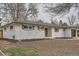 Quaint brick home with green shutters and a nicely landscaped front yard at 9455 W 37Th Ave, Wheat Ridge, CO 80033