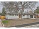 Charming brick home featuring a well maintained lawn and a two-car garage at 9455 W 37Th Ave, Wheat Ridge, CO 80033