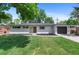 Charming single-story home featuring a well-maintained lawn, white brick exterior, dark shutters and a one-car garage at 9455 W 37Th Ave, Wheat Ridge, CO 80033