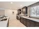 Modern kitchen featuring dark cabinets, stainless steel appliances, and tile backsplash, with ample counter space at 9455 W 37Th Ave, Wheat Ridge, CO 80033