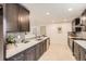 Modern kitchen features sleek dark cabinets, stainless steel appliances, and bright white countertops at 9455 W 37Th Ave, Wheat Ridge, CO 80033