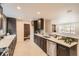 Modern kitchen features sleek dark cabinets, stainless steel appliances, and bright white countertops at 9455 W 37Th Ave, Wheat Ridge, CO 80033