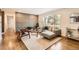 Bright living room featuring modern decor, beautiful hardwood floors, and a large window at 9455 W 37Th Ave, Wheat Ridge, CO 80033