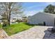 Backyard showcasing a brick patio, well-maintained lawn, and the building's exterior at 6245 W 53Rd Ave, Arvada, CO 80002