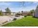 Spacious backyard featuring a concrete patio with a modern fire pit and well-manicured lawn at 6245 W 53Rd Ave, Arvada, CO 80002