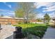 Spacious backyard featuring lush green grass, a patio, and a wooden fence at 6245 W 53Rd Ave, Arvada, CO 80002