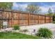 The fenced backyard includes a concrete patio, lush green grass, and landscape rock accents at 6245 W 53Rd Ave, Arvada, CO 80002