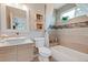 Well-lit bathroom featuring a vessel sink, modern vanity, and tiled shower-tub combination at 6245 W 53Rd Ave, Arvada, CO 80002