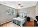 Cozy bedroom with hardwood floors, a ceiling fan, a window and comfortable furnishings at 6245 W 53Rd Ave, Arvada, CO 80002