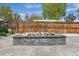 Close-up of a modern firepit in a fenced backyard, with unique skull accents along the top edge at 6245 W 53Rd Ave, Arvada, CO 80002