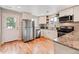 Efficient kitchen features stainless appliances, granite countertops and white cabinets for a modern touch at 6245 W 53Rd Ave, Arvada, CO 80002