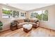 Bright living room with hardwood floors, a large window, and stylish sectional sofa at 6245 W 53Rd Ave, Arvada, CO 80002