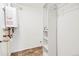 Utility room features a tankless hot water heater and built-in shelving for ample storage at 6245 W 53Rd Ave, Arvada, CO 80002