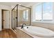 Modern bathroom with a separate tub and shower, framed in black to match faucet and hardware at 8346 Cokedale Cir, Littleton, CO 80125