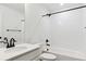 Bathroom featuring a single sink, white cabinets, black hardware, and a shower-tub combination at 8346 Cokedale Cir, Littleton, CO 80125