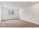 A bright bedroom with neutral carpet, white walls and trim, and a window for natural light at 8346 Cokedale Cir, Littleton, CO 80125