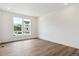 Well-lit room with hardwood floors, white walls, large windows offering natural light and neighborhood views at 8346 Cokedale Cir, Littleton, CO 80125