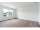 Bright bedroom with plush carpet, white walls, and two windows providing lots of natural light at 8346 Cokedale Cir, Littleton, CO 80125