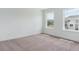 Well-lit bedroom with plush carpet, white walls, and two windows providing lots of natural light at 8346 Cokedale Cir, Littleton, CO 80125