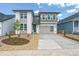 Modern two-story home with a two-car garage, manicured front yard, and a combination of brick and gray siding at 8346 Cokedale Cir, Littleton, CO 80125