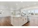 Modern kitchen island features a sink, stainless steel dishwasher, and overlooks the living area with ample natural light at 8346 Cokedale Cir, Littleton, CO 80125