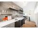 Wet bar with modern lighting and floating shelves, with a view of a living area at 3727 Tejon St, Denver, CO 80211