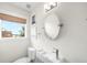 Modern powder room featuring floating sink and toilet, with a window view at 3727 Tejon St, Denver, CO 80211