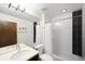 Bright bathroom featuring a large mirror and tiled bathtub and shower at 3727 Tejon St, Denver, CO 80211