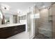 Modern bathroom featuring double vanity, glass shower with bench, and neutral tile at 3727 Tejon St, Denver, CO 80211