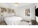Bright bedroom with a white bed frame, cozy carpet, and modern decor at 3727 Tejon St, Denver, CO 80211