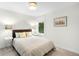 Bright bedroom featuring a tan bedspread, modern decor, and a large window at 3727 Tejon St, Denver, CO 80211