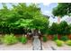 Inviting front yard with lush greenery, decorative shrubs, and a concrete walkway leading to the house at 3727 Tejon St, Denver, CO 80211