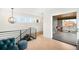 Bright hallway featuring light wood floors and sliding glass door leading to an outdoor patio at 3727 Tejon St, Denver, CO 80211