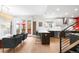 Modern kitchen and living area with stainless appliances, island seating, and hardwood floors at 3727 Tejon St, Denver, CO 80211