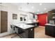Contemporary kitchen with stainless appliances, island seating, and modern pendant lighting at 3727 Tejon St, Denver, CO 80211
