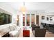 Inviting living room featuring hardwood floors, a cozy sofa, and access to the outdoor patio at 3727 Tejon St, Denver, CO 80211