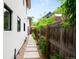 Property side yard featuring a stone pathway, garden bed, and wooden fence at 3727 Tejon St, Denver, CO 80211